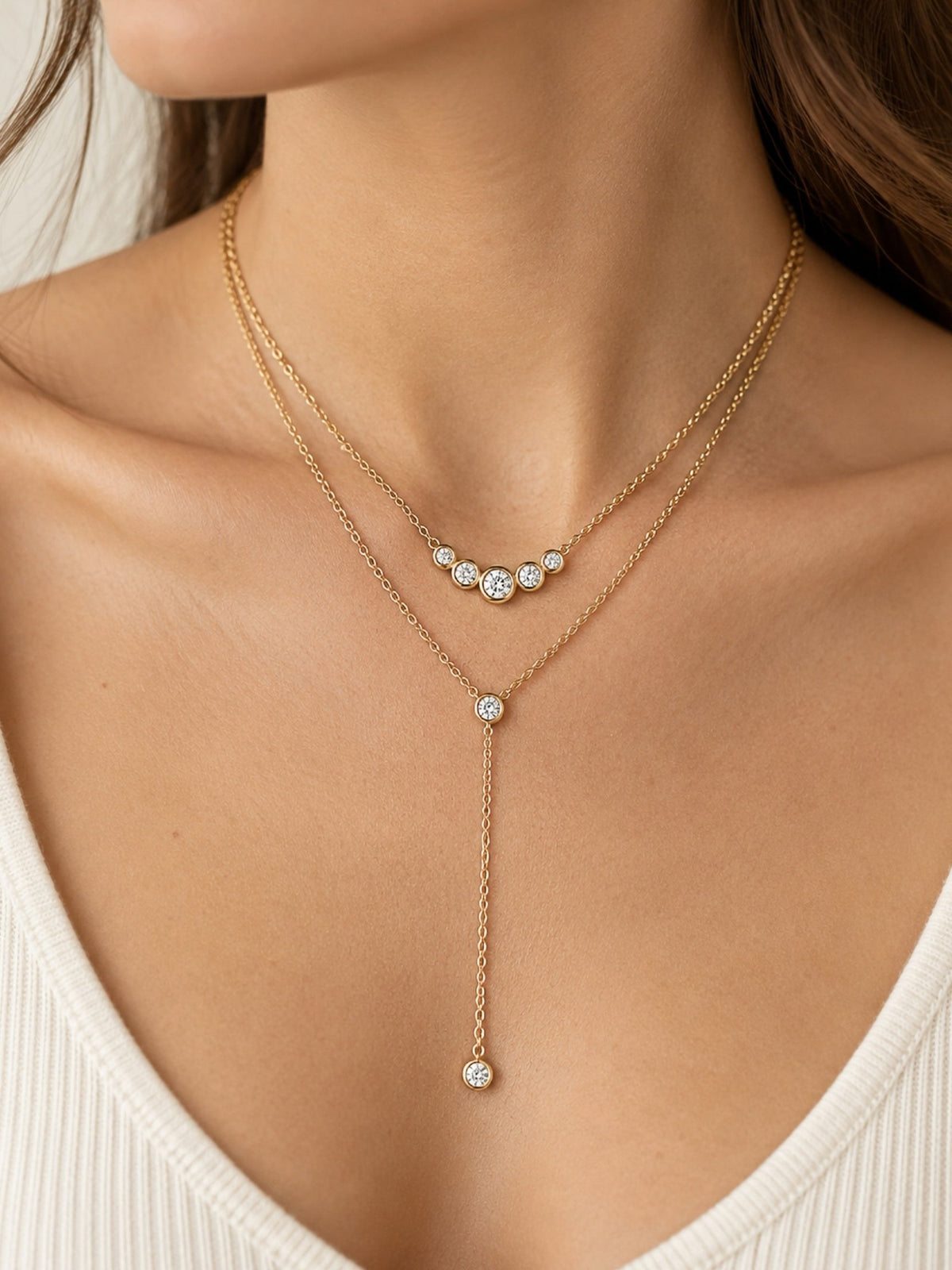Gold-tone lariat necklace with three-stone choker and teardrop-style drop charm