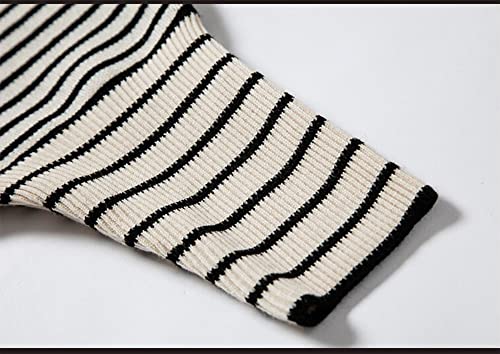 Ribbed striped knit cuff on black poncho sweater with cream and dark lines