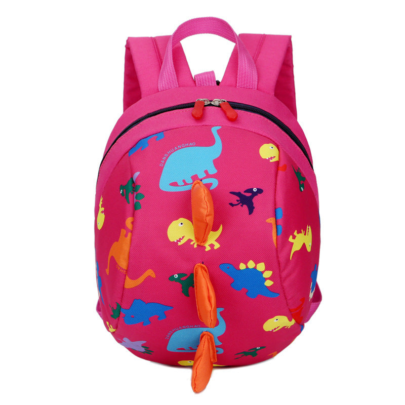 Pink kids dinosaur print backpack with front zipper and dangling orange charm tags