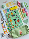 Cat-themed notebook and mint zipper pouch with patches and stationery accessories
