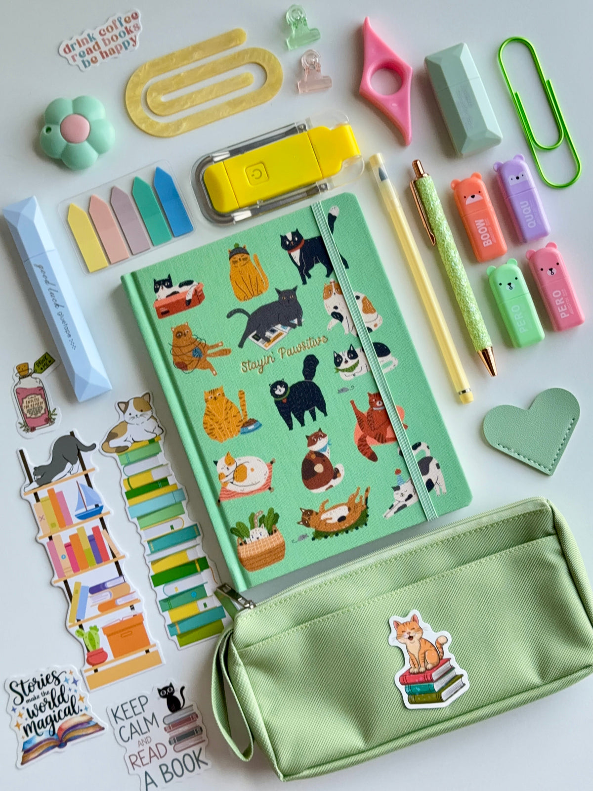 Cat-themed notebook and mint zipper pouch with patches and stationery accessories