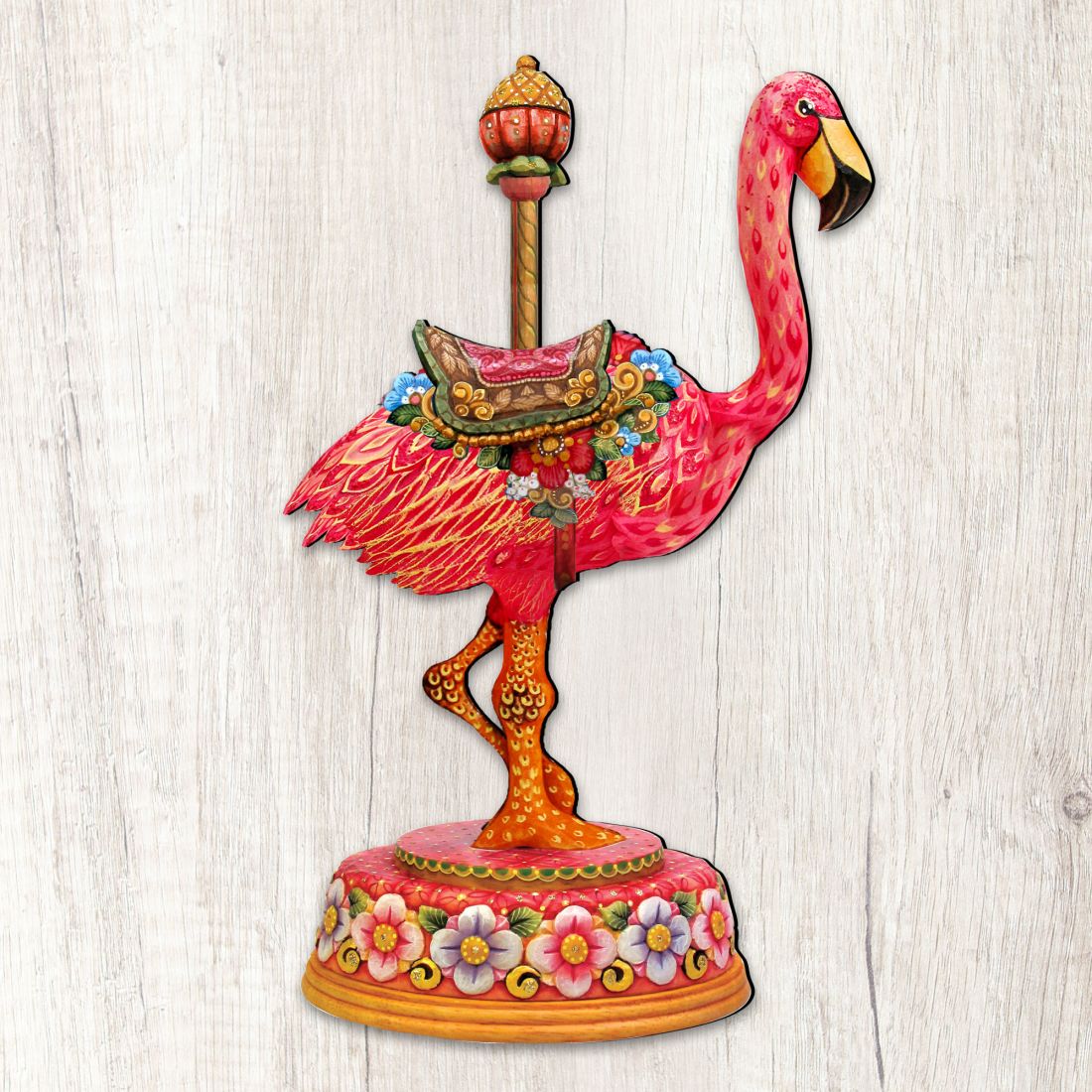 Close-up flamingo Christmas ornament with red body and floral pedestal
