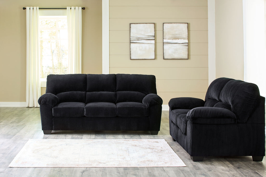 Dark navy loveseat with rolled arms and matching recliner