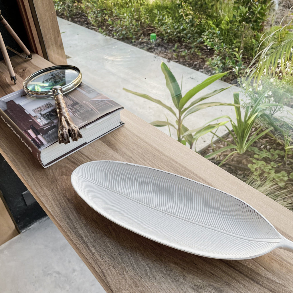 White leaf-shaped decorative tray with ribbed texture, oval serving surface