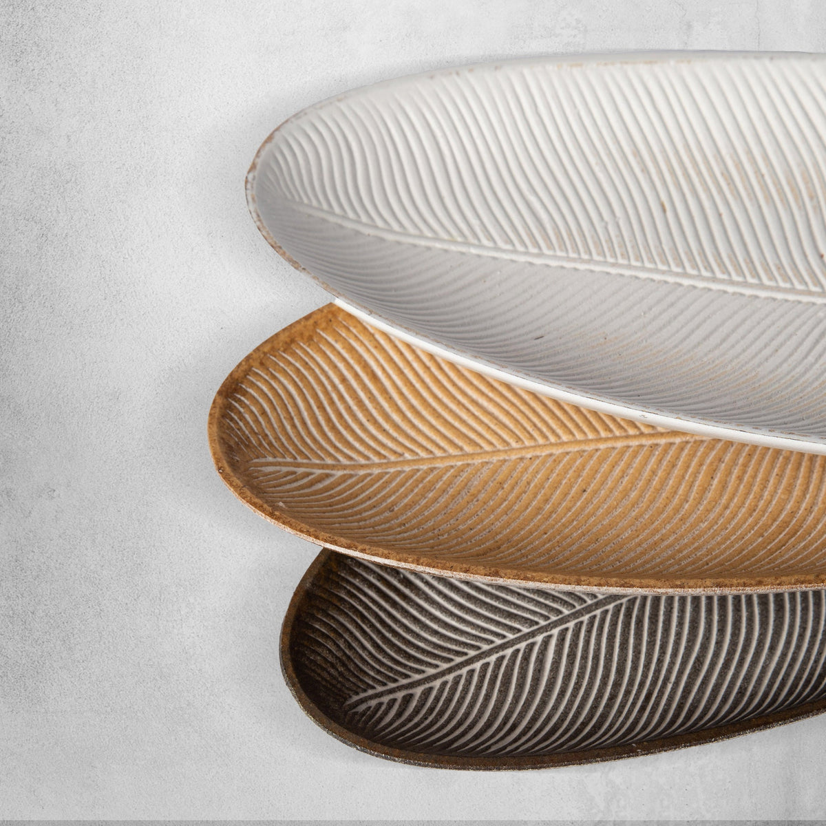 White leaf-shaped MDF tray with raised ribbed lines and smooth rim