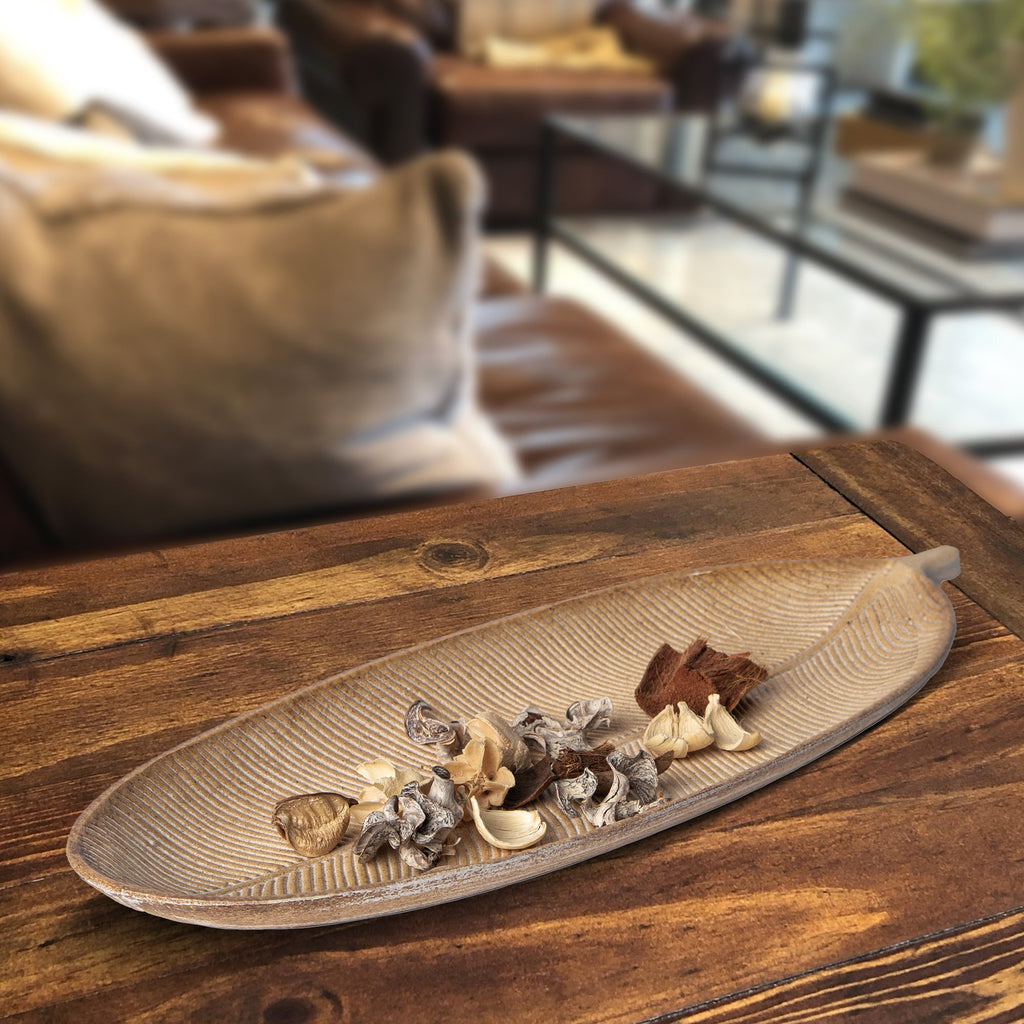 Brown leaf-shaped decorative tray with ribbed leaf pattern and dried floral decor