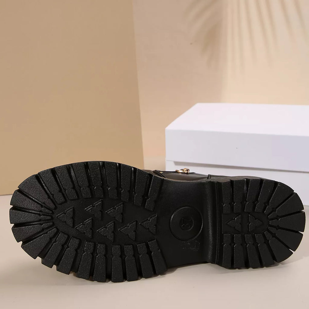 Black boot outsole with deep tread pattern