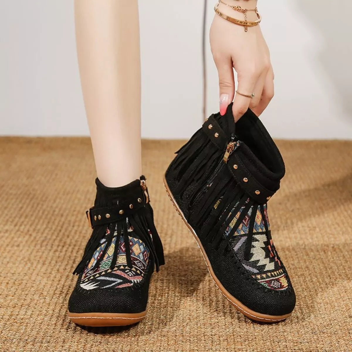 Black fringe ankle boots with side zipper, studded detail, and patterned side panels