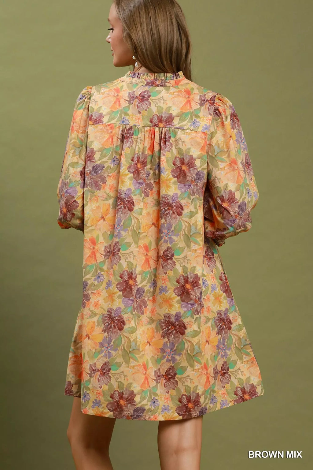 Back view of floral mini dress with smocked cuffs and gathered yoke, brown mix