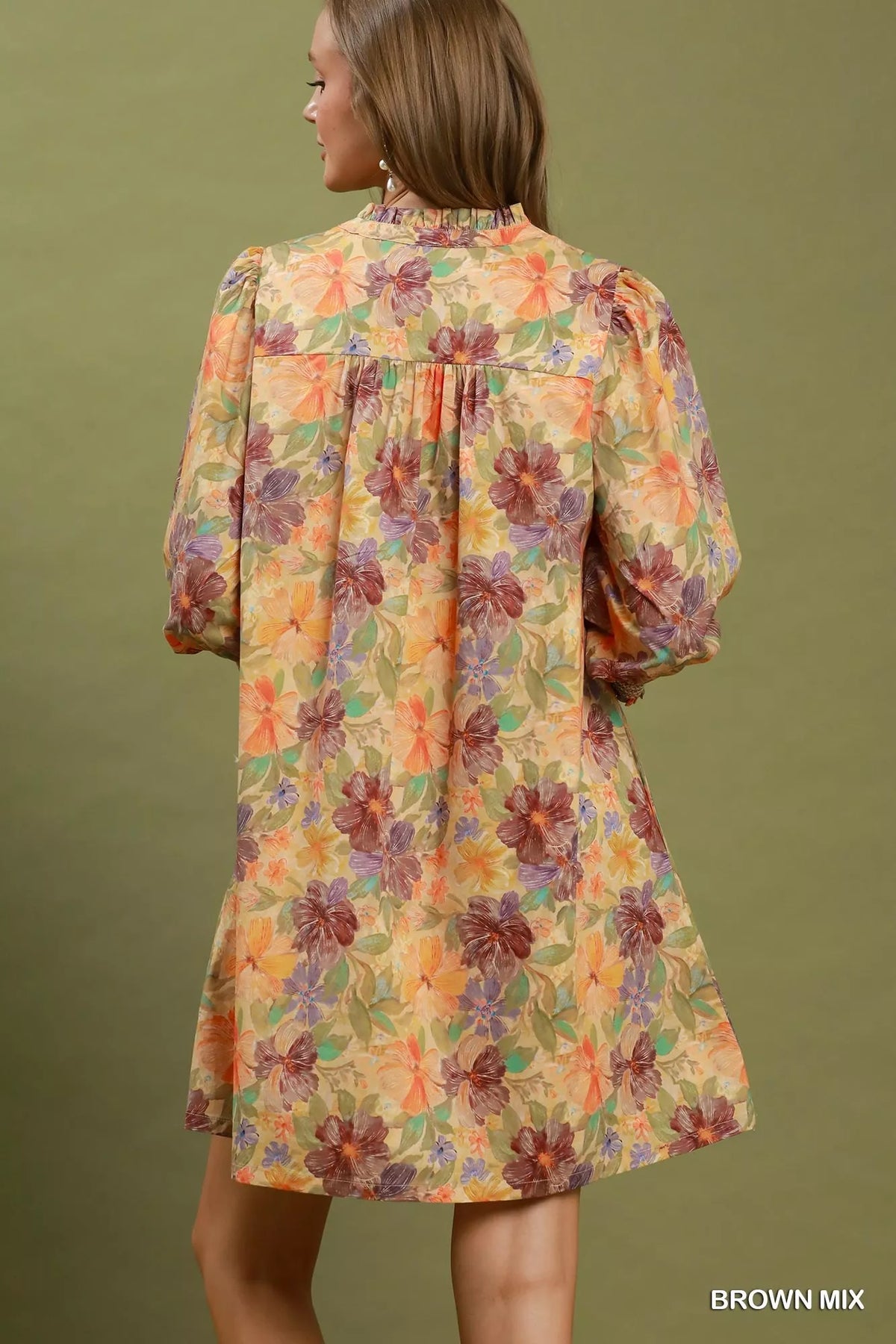 Back view of floral mini dress with smocked cuffs and gathered yoke, brown mix