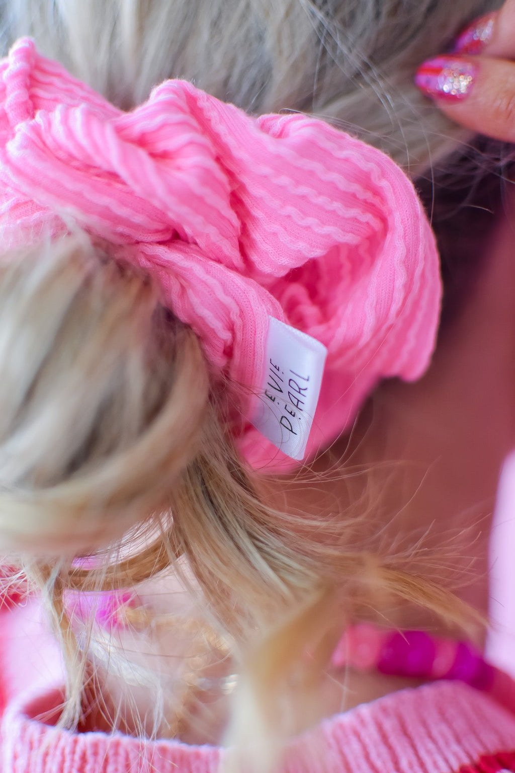 Pink ribbed scrunchy with white brand tag