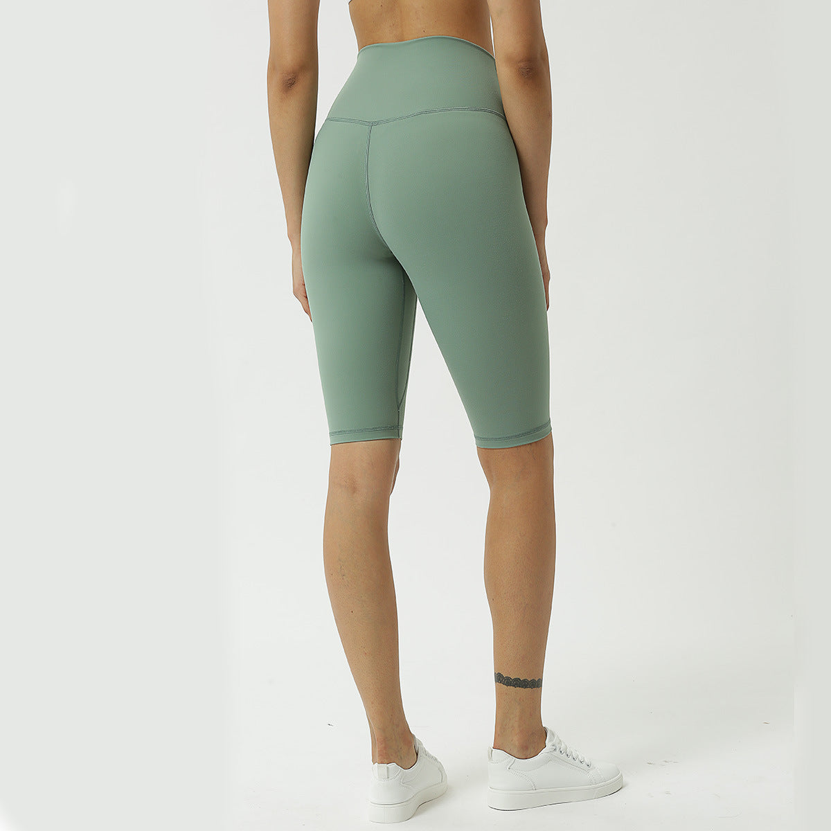 High-waist forest green yoga capri pants, back view