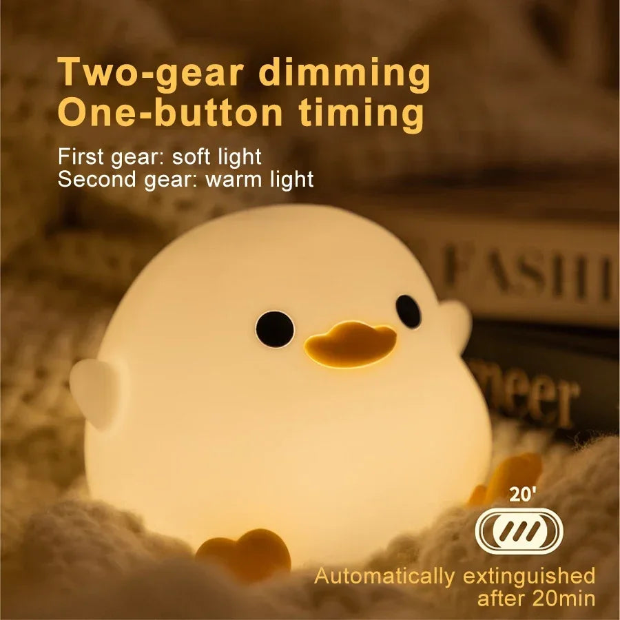 Glowing duck silicone night light with smiling face and heart feet on display