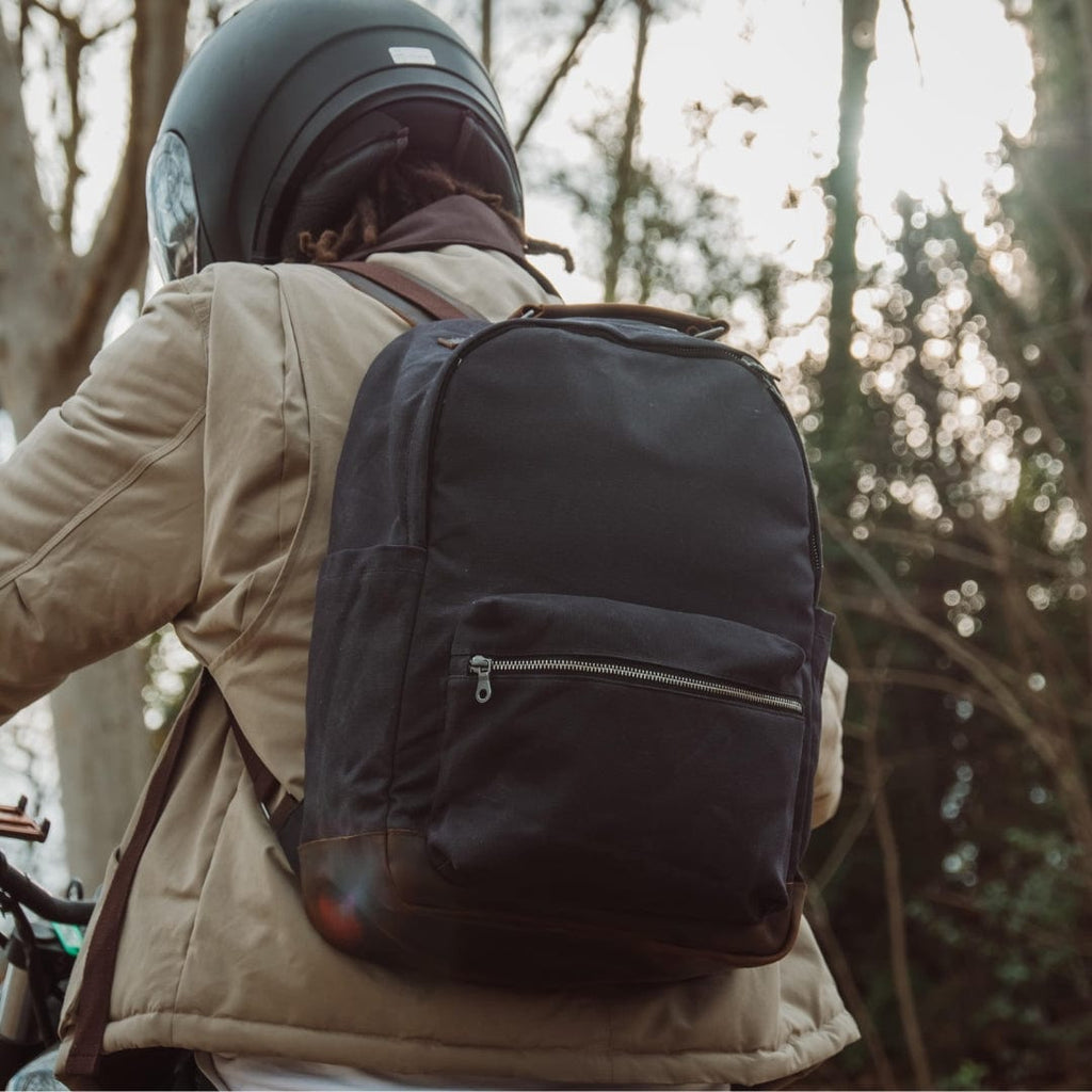 Dark backpack with front zipper pocket and padded shoulder straps