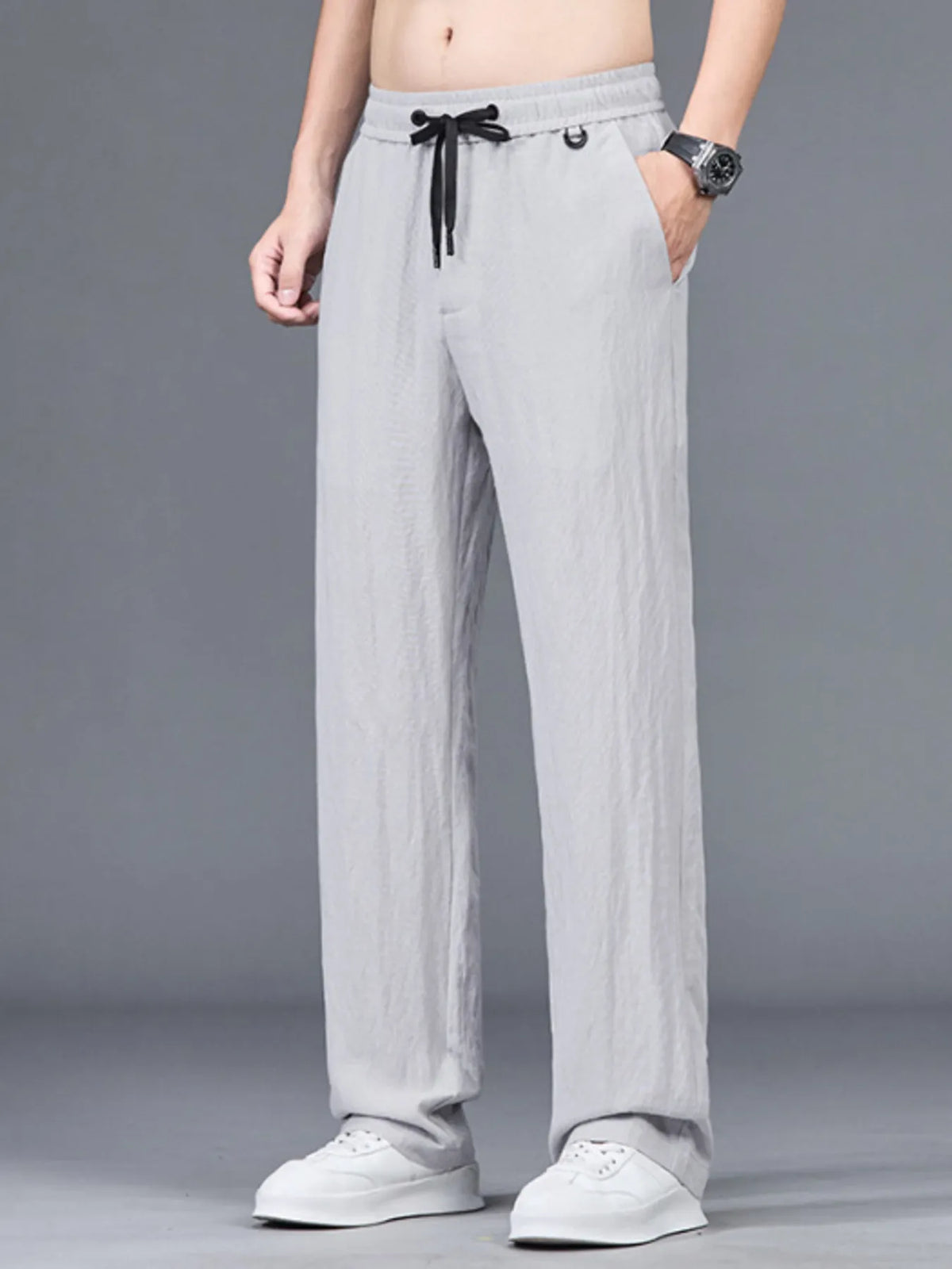 Lightweight casual pants in light gray with elastic waist and drawstring hem pockets