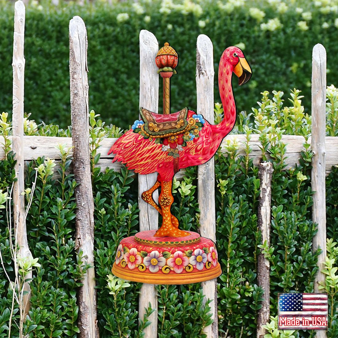 Outdoor flamingo Christmas ornament standing on a round floral base