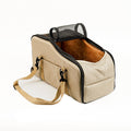 Beige portable pet car seat cushion with front zipper pockets and adjustable shoulder strap