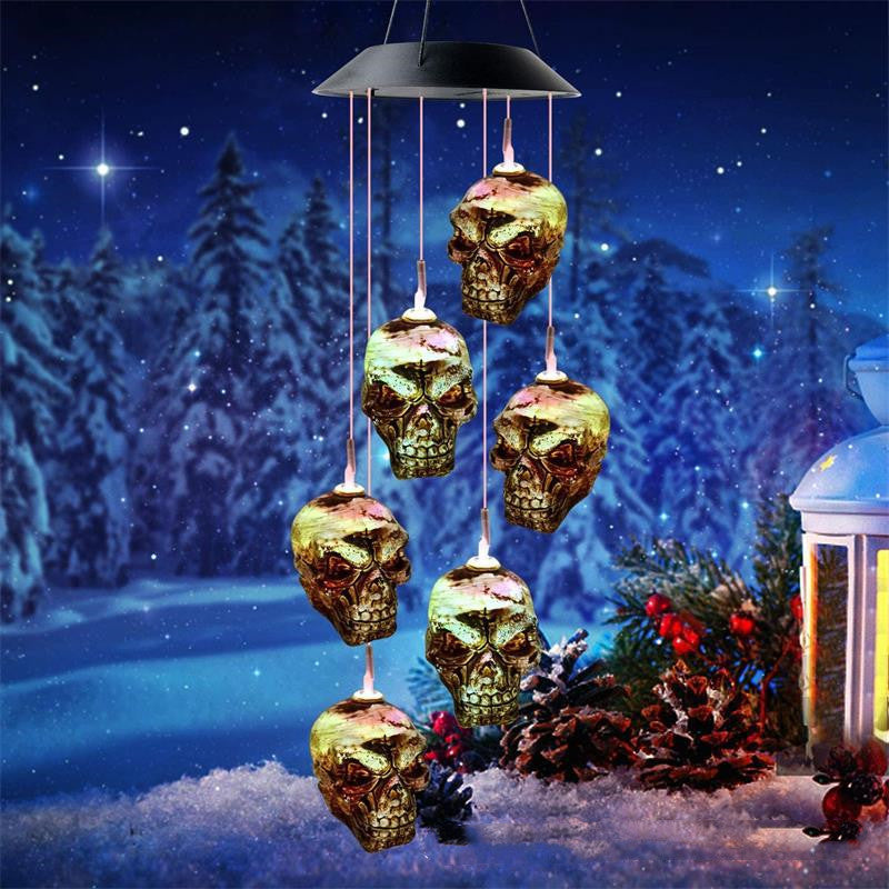 Solar LED skull wind chime with warm glowing skull ornaments