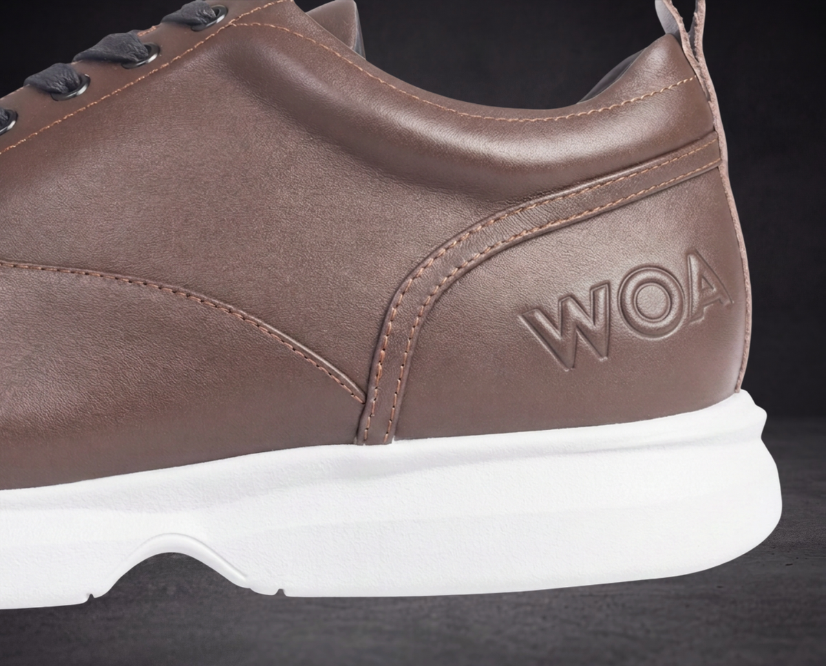 WOA brown sneaker side profile with embossed logo, contrast stitching, white sole