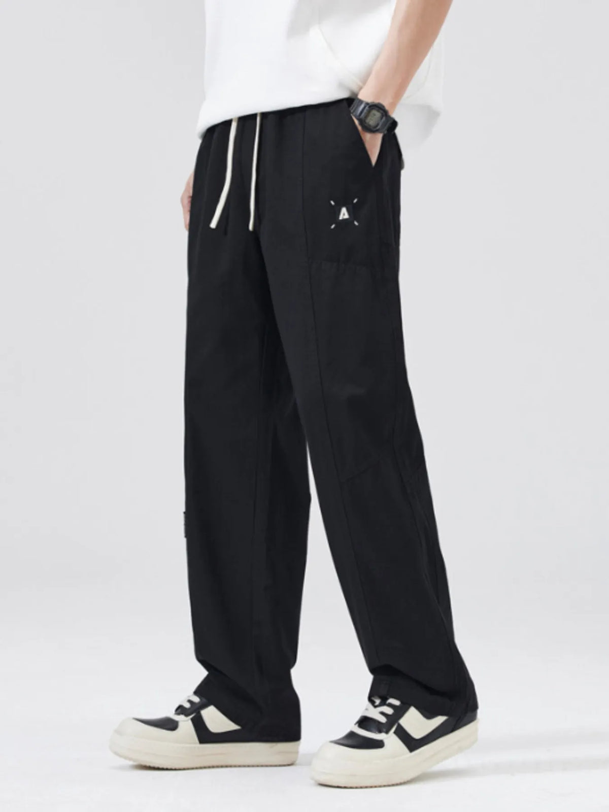 Black loose-fit drawstring pants with cuffed hems and side pockets