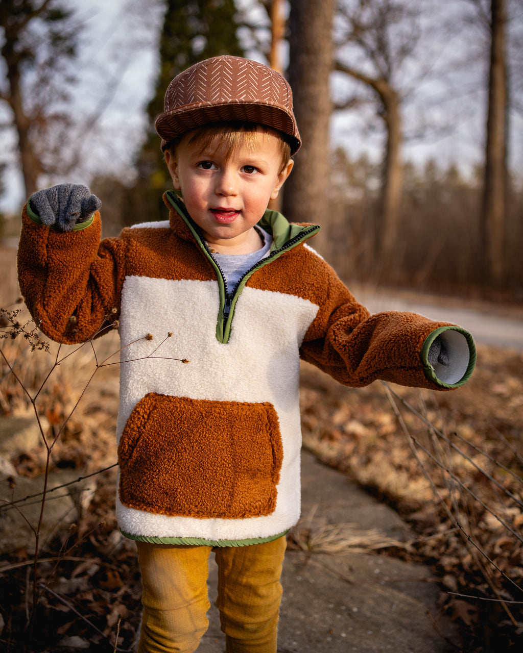 Sherpa pullover sweatshirt in brown with white front panel, green hood edging
