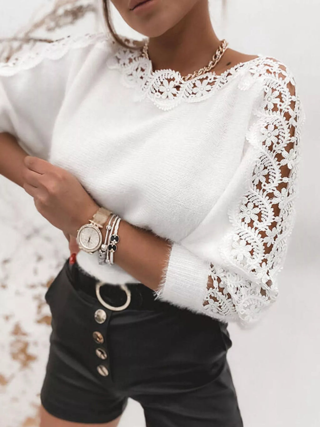 White long-sleeve sweater with round neckline and floral lace trim on shoulders and cuffs