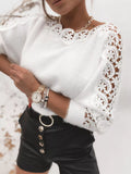 White long-sleeve sweater with round neckline and floral lace trim on shoulders and cuffs