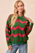 Green chevron knit sweater with red zigzag sequin detail and long sleeves