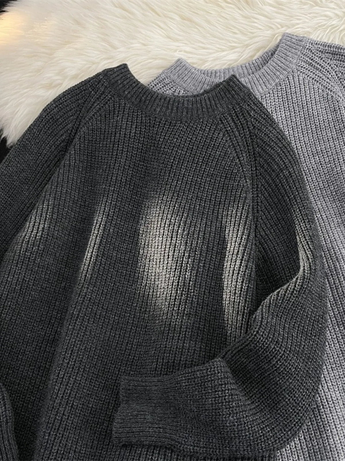 Dark gray knit round-neck sweater, long sleeve with ribbed cuff and hem detail