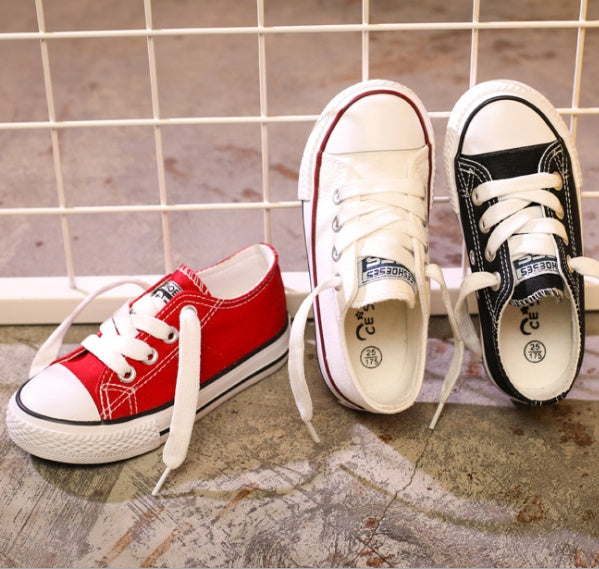 Red and black lace-up canvas sneakers with white laces and rubber soles