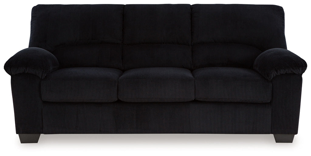 Upholstered sofa in dark fabric with plush padded arms and tufted seat cushions