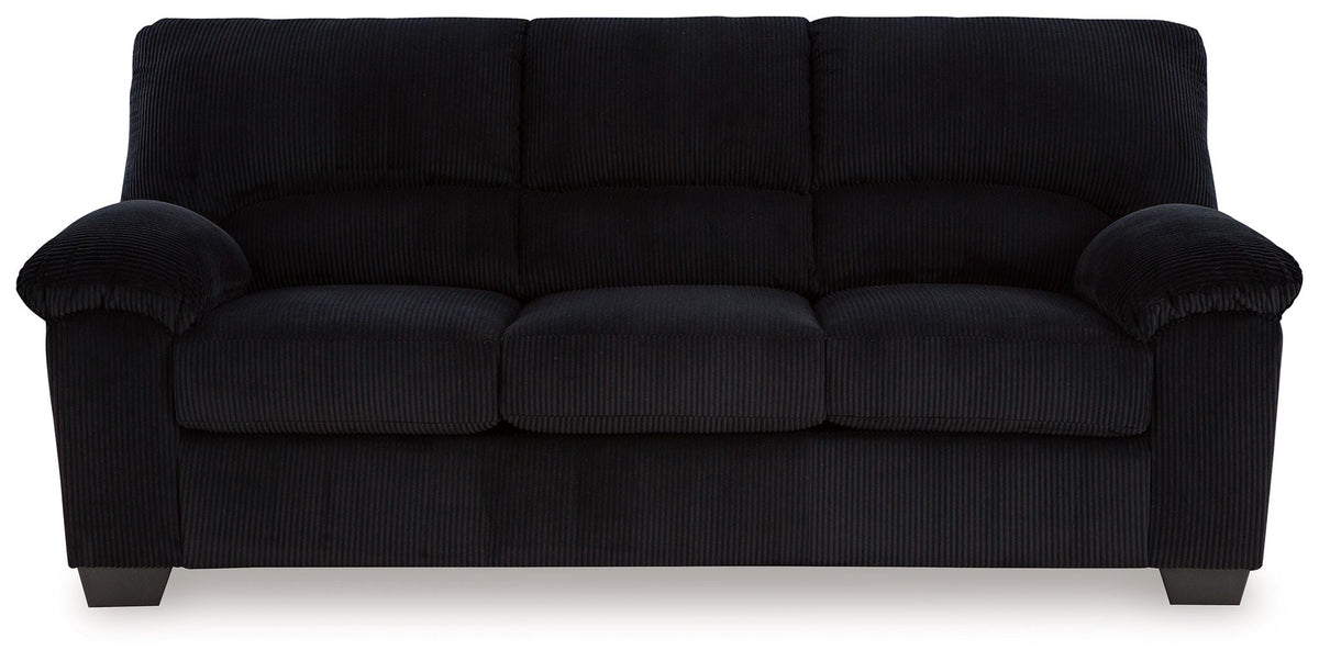 Upholstered sofa in dark fabric with plush padded arms and tufted seat cushions