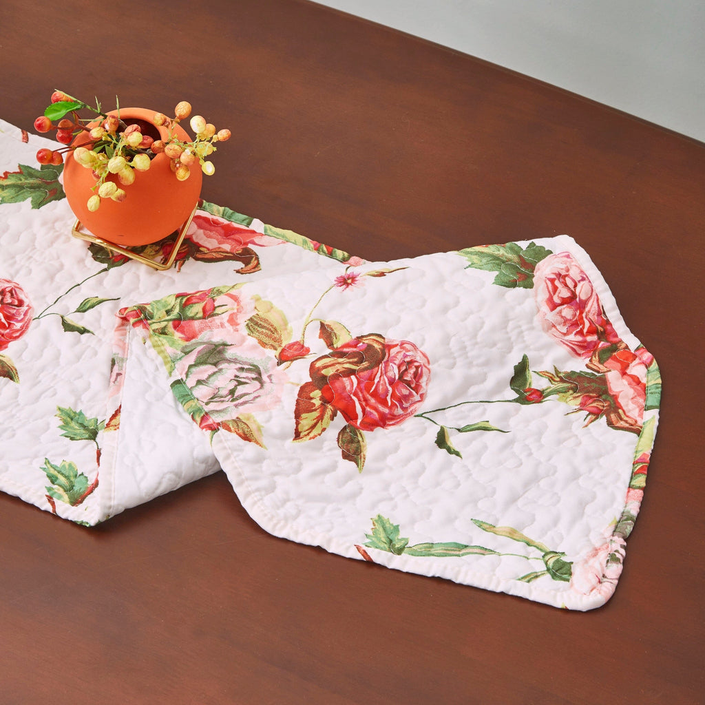 Quilted dining table runner with rose bouquet print and visible stitched quilting texture