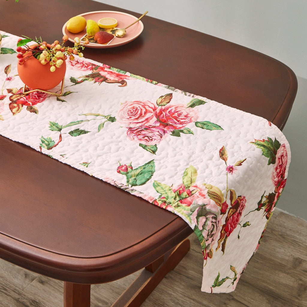Quilted dining table runner, white with pink roses and green leaves, scalloped corner fold