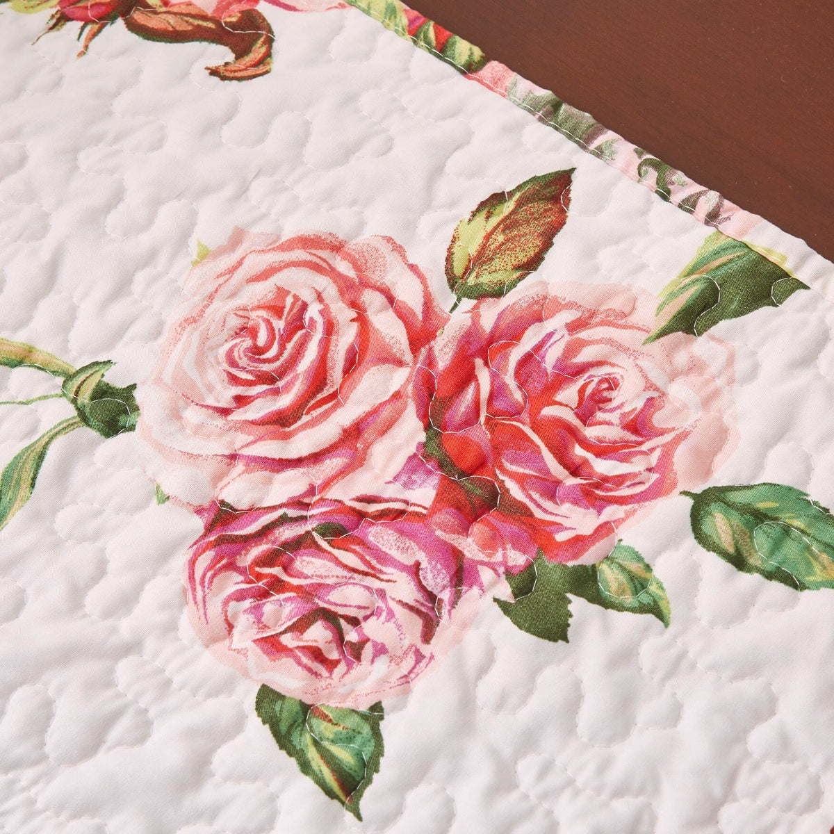 Quilted dining table runner corner with large pink roses and green foliage on white