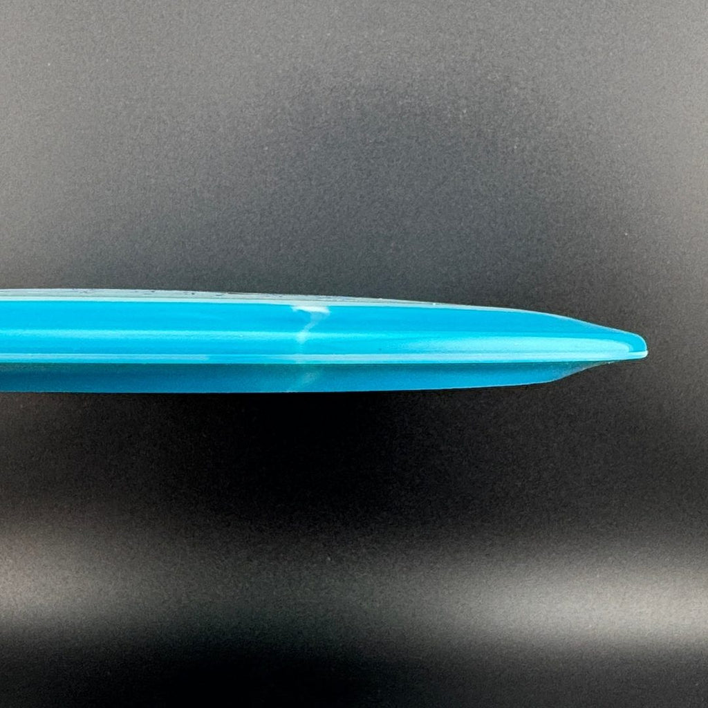 Light blue disc golf disc edge view with smooth outer rim