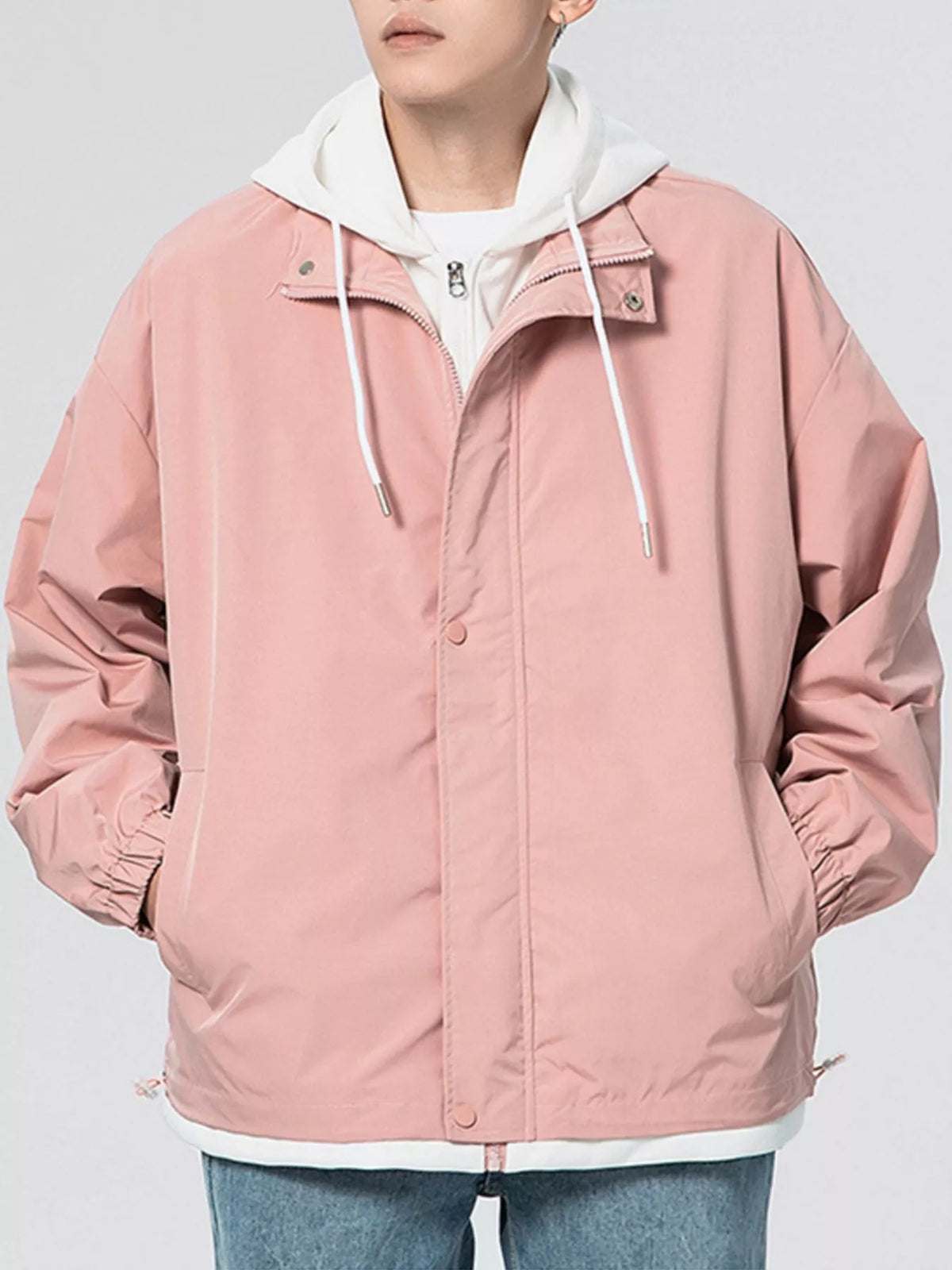 Pink lightweight windbreaker jacket with hood and front zipper, drawstring cords