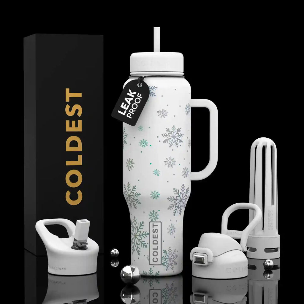 White insulated tumbler with snowflake print, handle, straw, and leakproof lid.