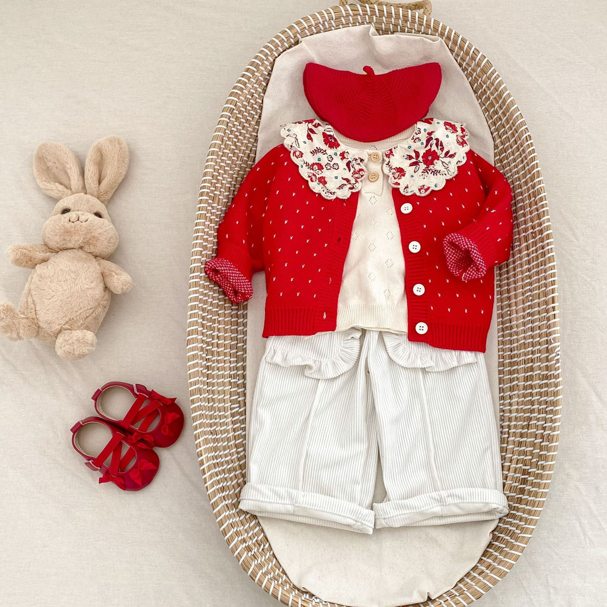 Red knit cardigan with tiny dots, button front, and floral lace collar detail