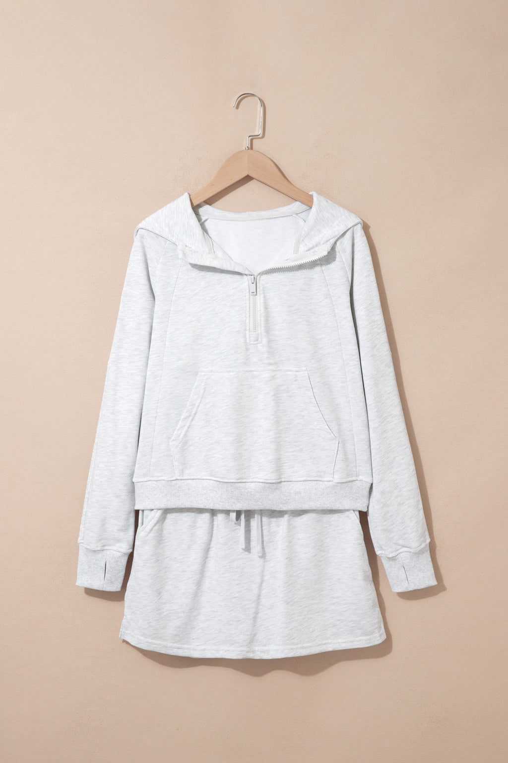 Light grey zip hoodie and skort set, front view on hanger
