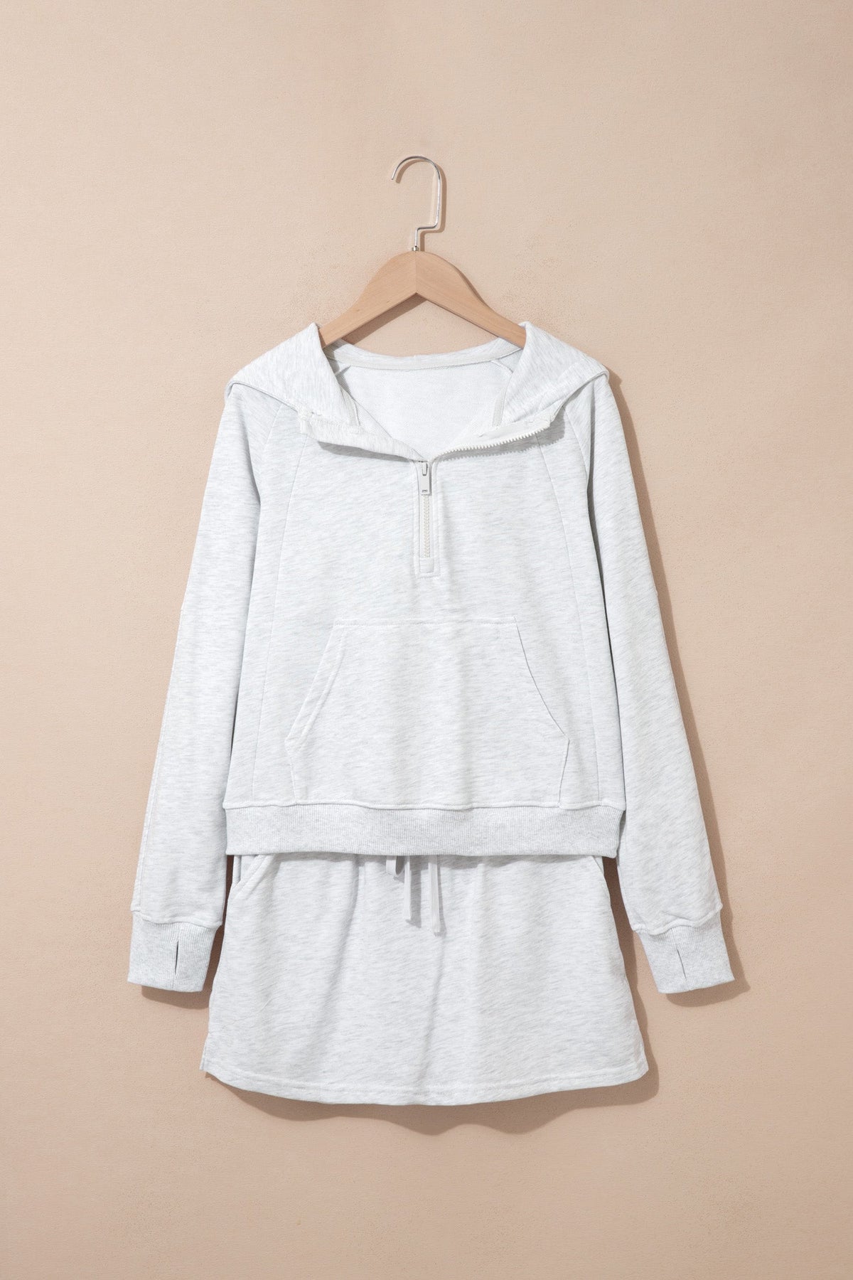 Light grey zip hoodie and skort set, front view on hanger