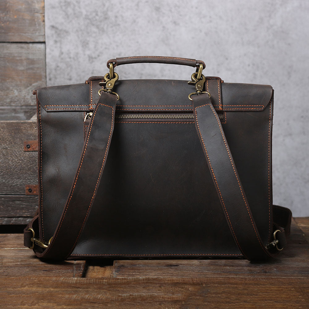 Brown leather briefcase messenger bag with top handle, front buckles, and crossbody strap