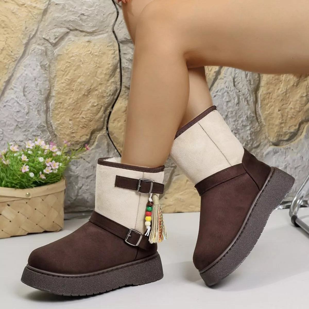 Two-tone ankle boots with white uppers, brown sides, buckles, and tassel charms.