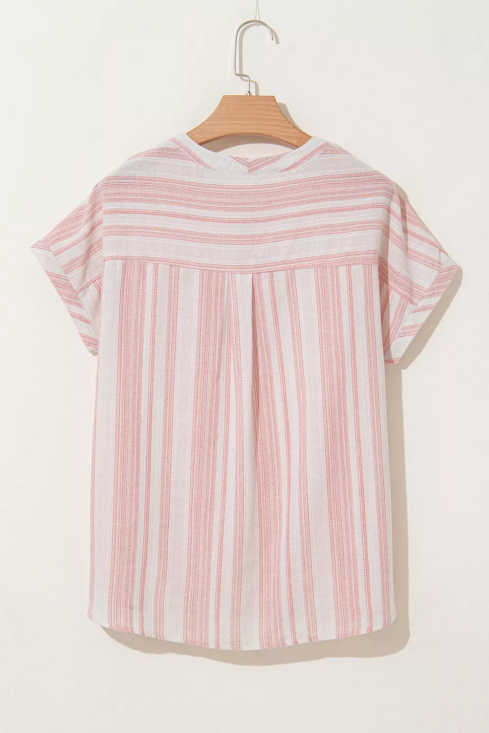 Dusty pink striped short-sleeve blouse on hanger, back view