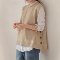 Apricot knit sleeveless sweater vest with ribbed high neck and side button details