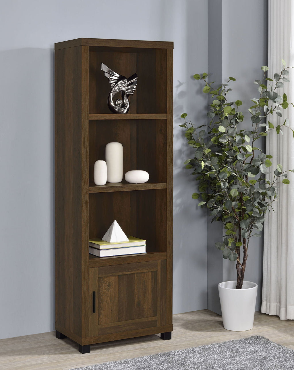 Dark pine media tower with open shelves and lower cabinet door in living room