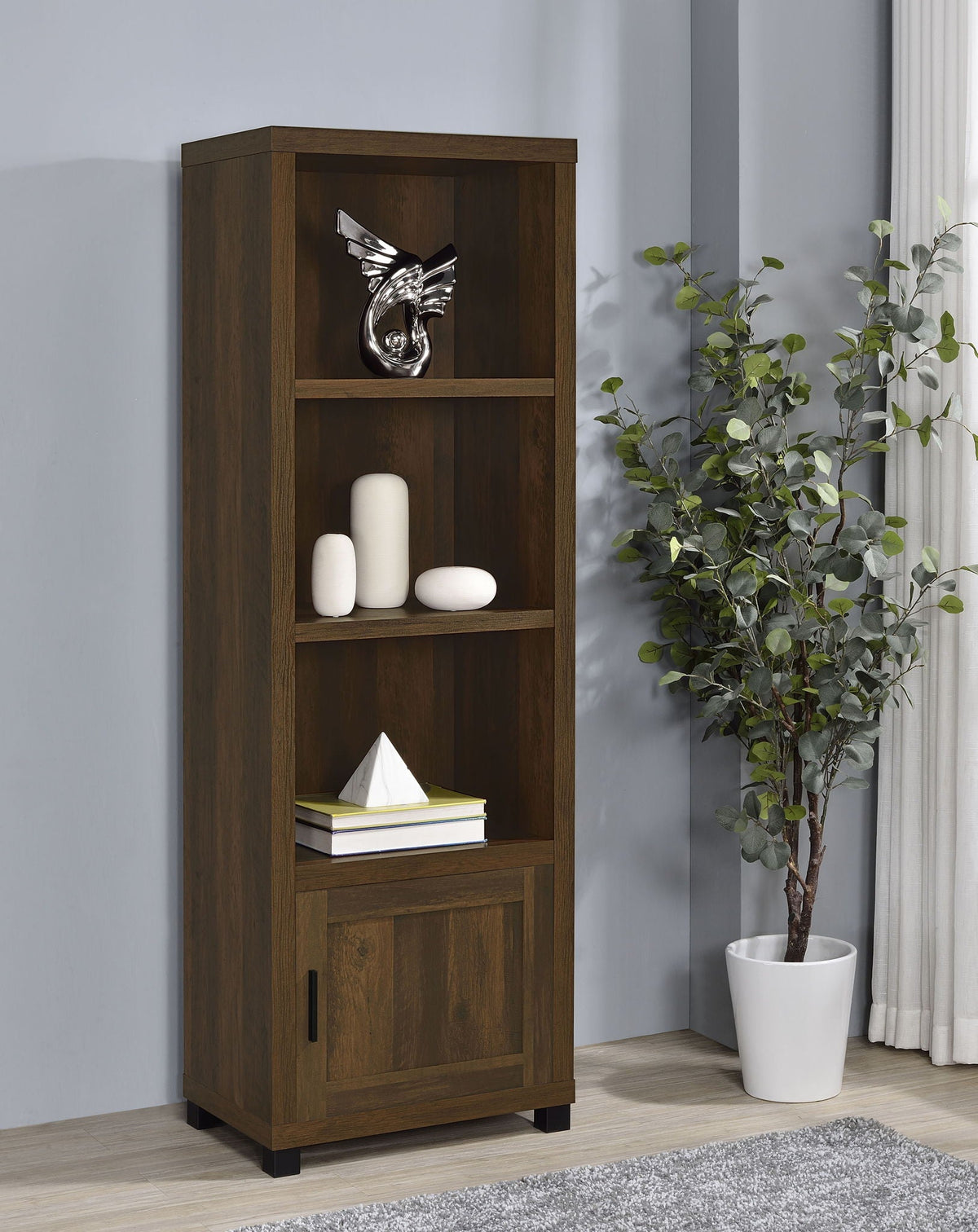 Dark pine media tower with open shelves and lower cabinet door in living room