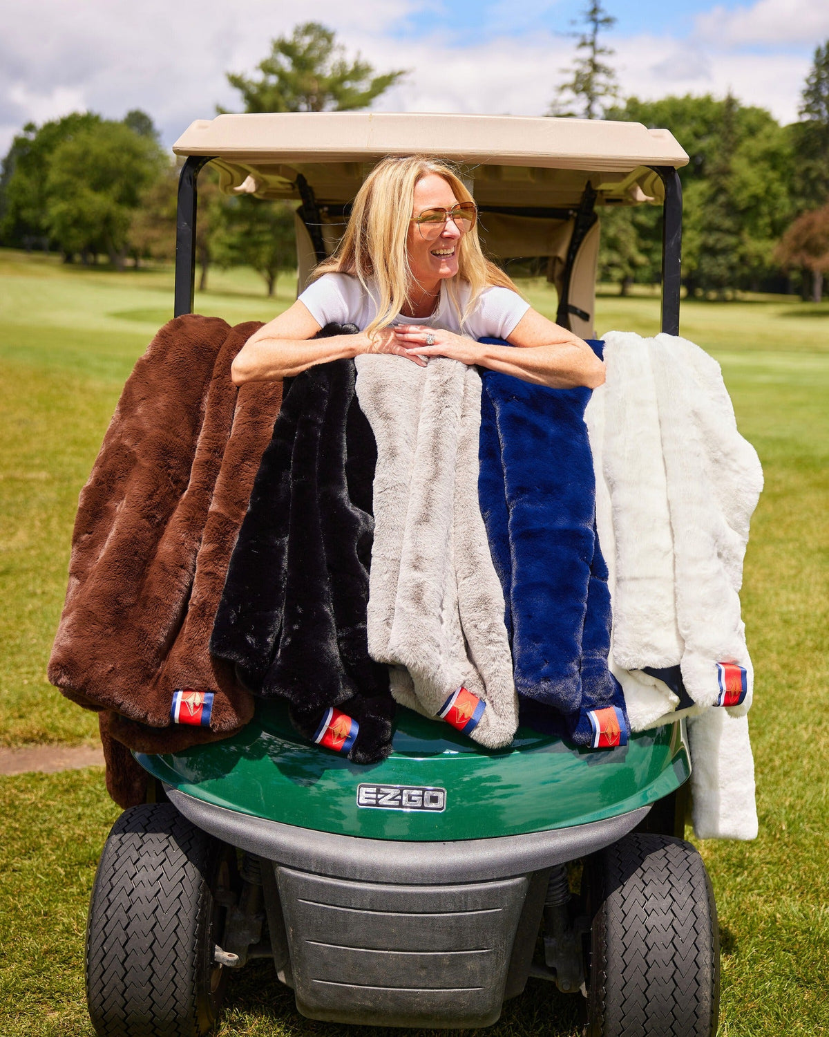 Outdoor blanket stack in brown, black, blue, and white fleece