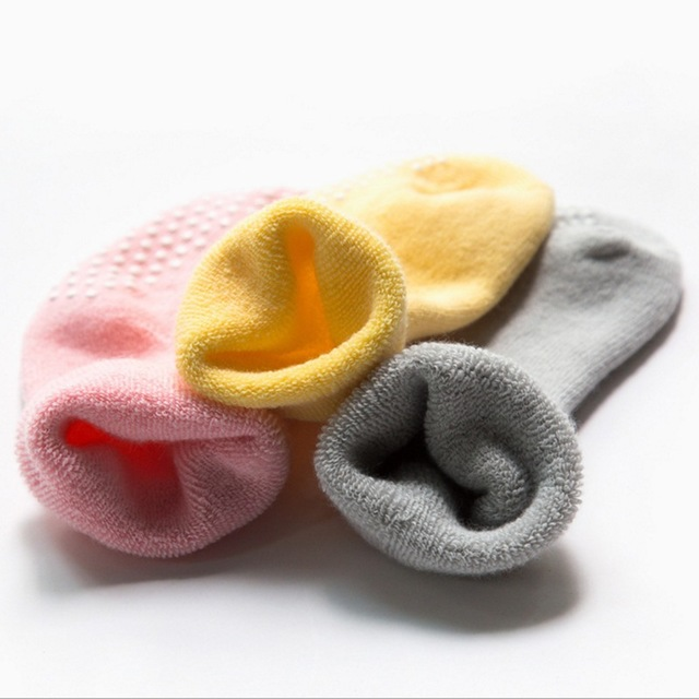 Children non-slip socks in pink, yellow, and grey with dotted grip soles