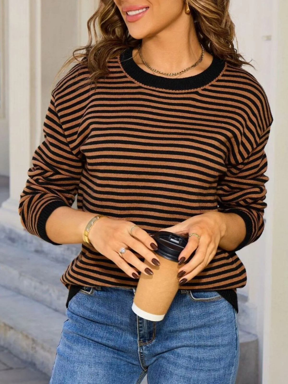 Black-and-tan striped round-neck sweater with relaxed fit and ribbed trim